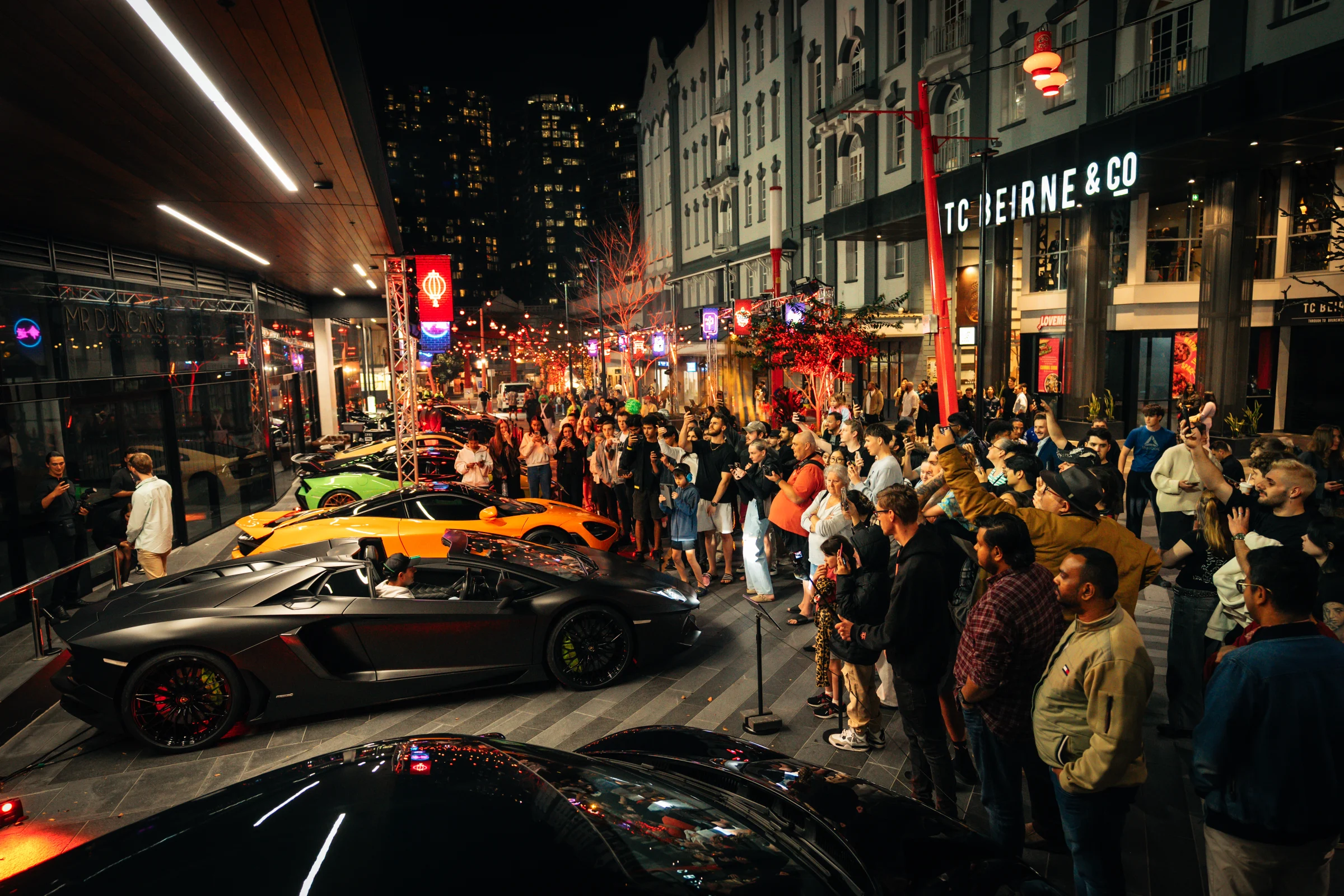 Supercars and a crowd at an MCA night event